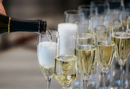 champagne poured into tall glasses